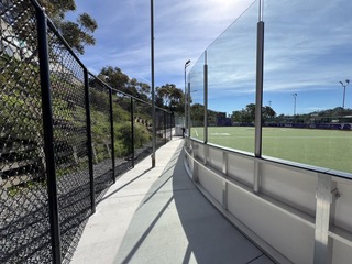 Black chain link fence along walkway