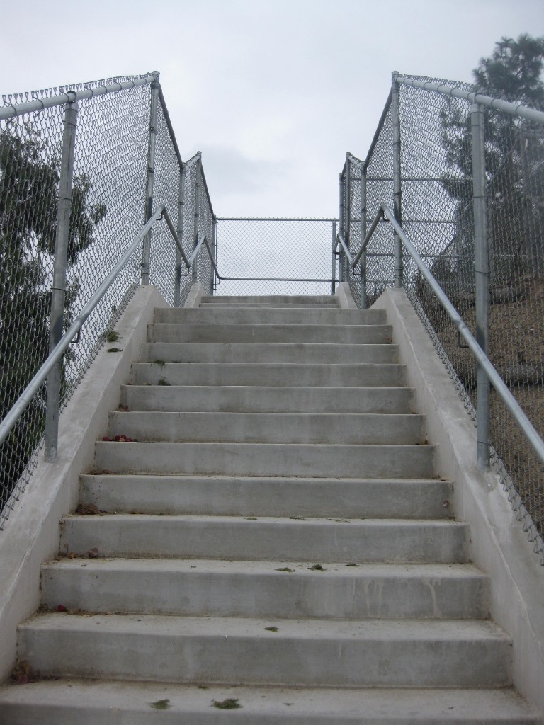 Chain link fence with stair handrail