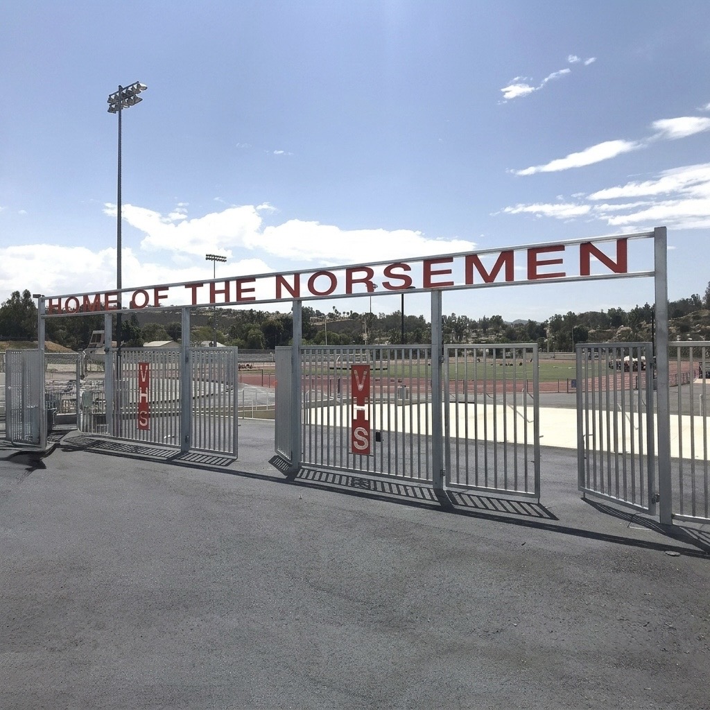 Custom iron school fence with Home of the Norsemen gate