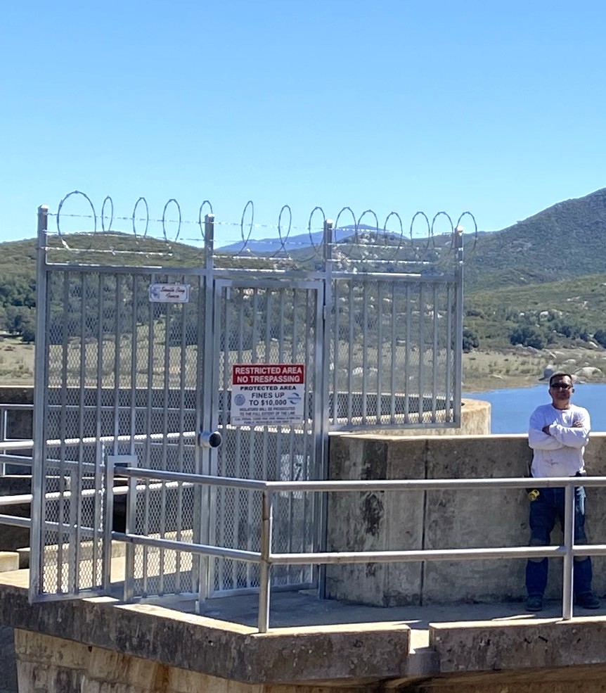 Dam security gate with razor wire